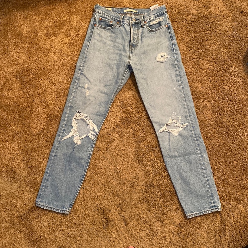 Size 25 Jeans with a few mild rips.